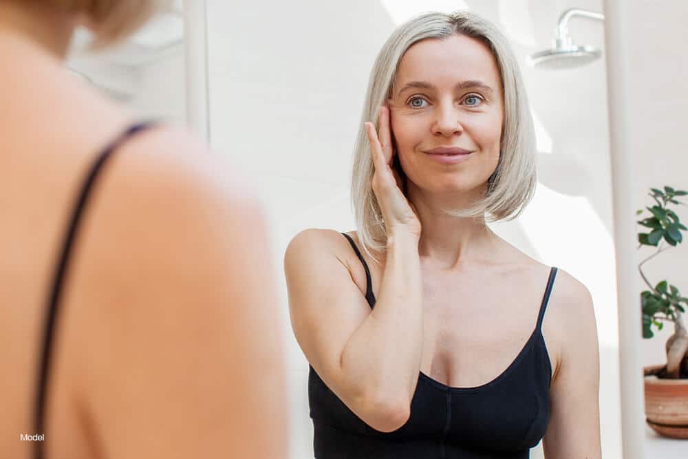 Mature woman touching her face